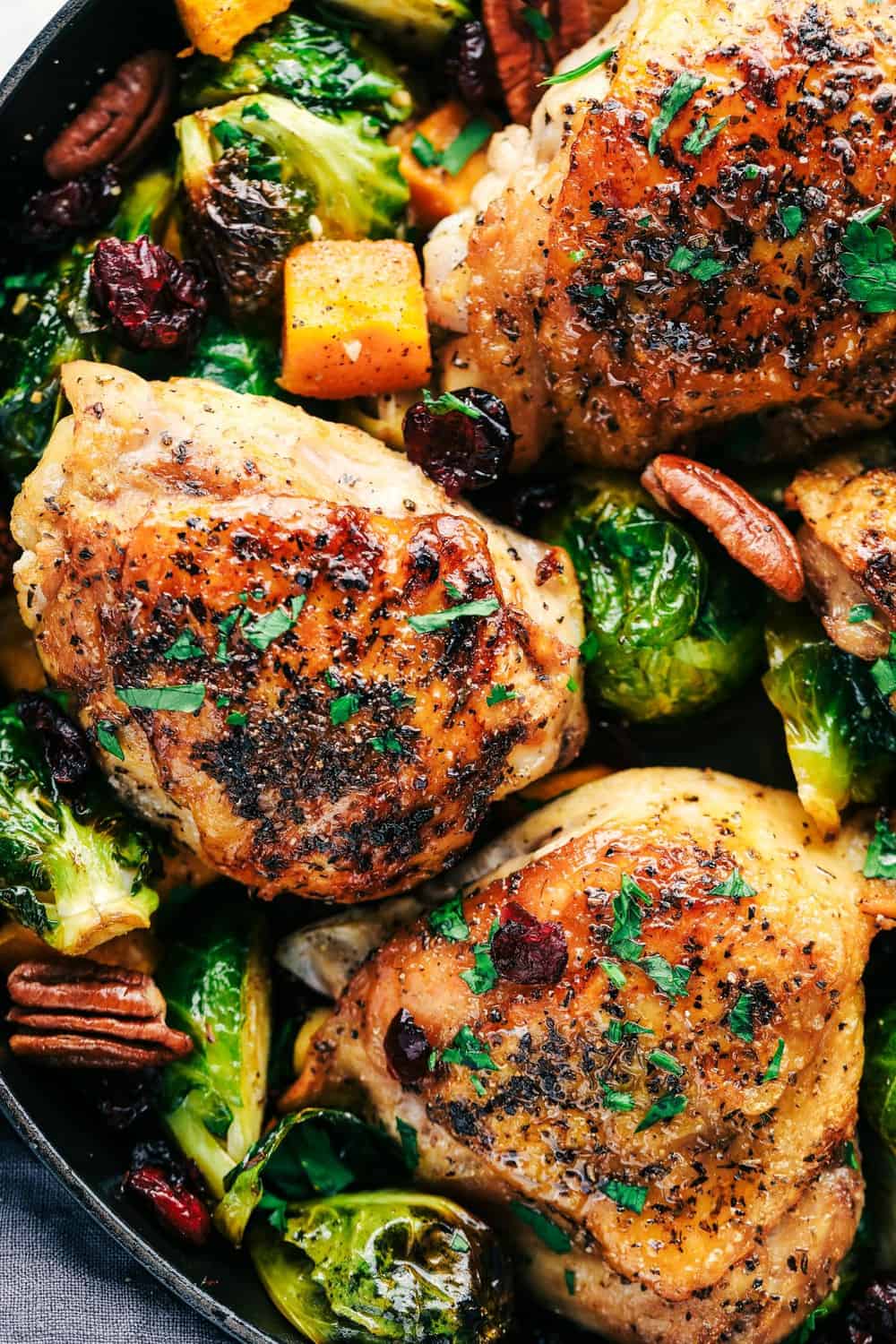 Roasted Honey Garlic Butter Chicken with Brussels Sprouts and Butternut Squash is a rustic and delicious meal that is full of amazing flavor. This is a comforting meal in one that is perfect for feeding your family! roasted honey and garlic butter chicken with Brussels sprouts and butternut squash