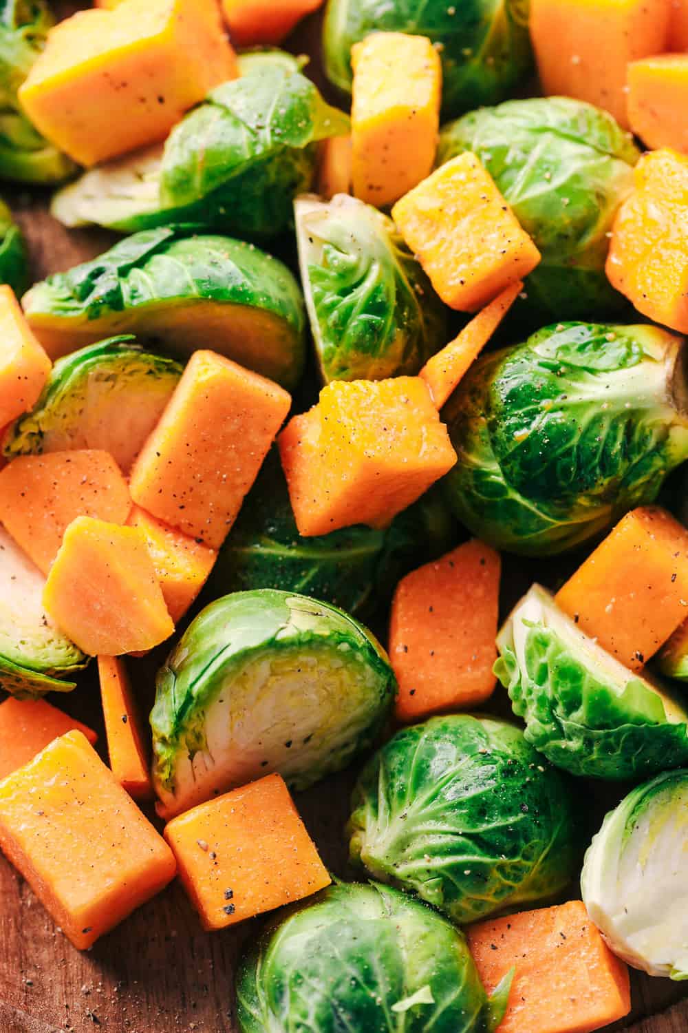 Roasted Honey Garlic Butter Chicken with Brussels Sprouts and Butternut Squash is a rustic and delicious meal that is full of amazing flavor. This is a comforting meal in one that is perfect for feeding your family! brussels sprouts and butternut squash cut up