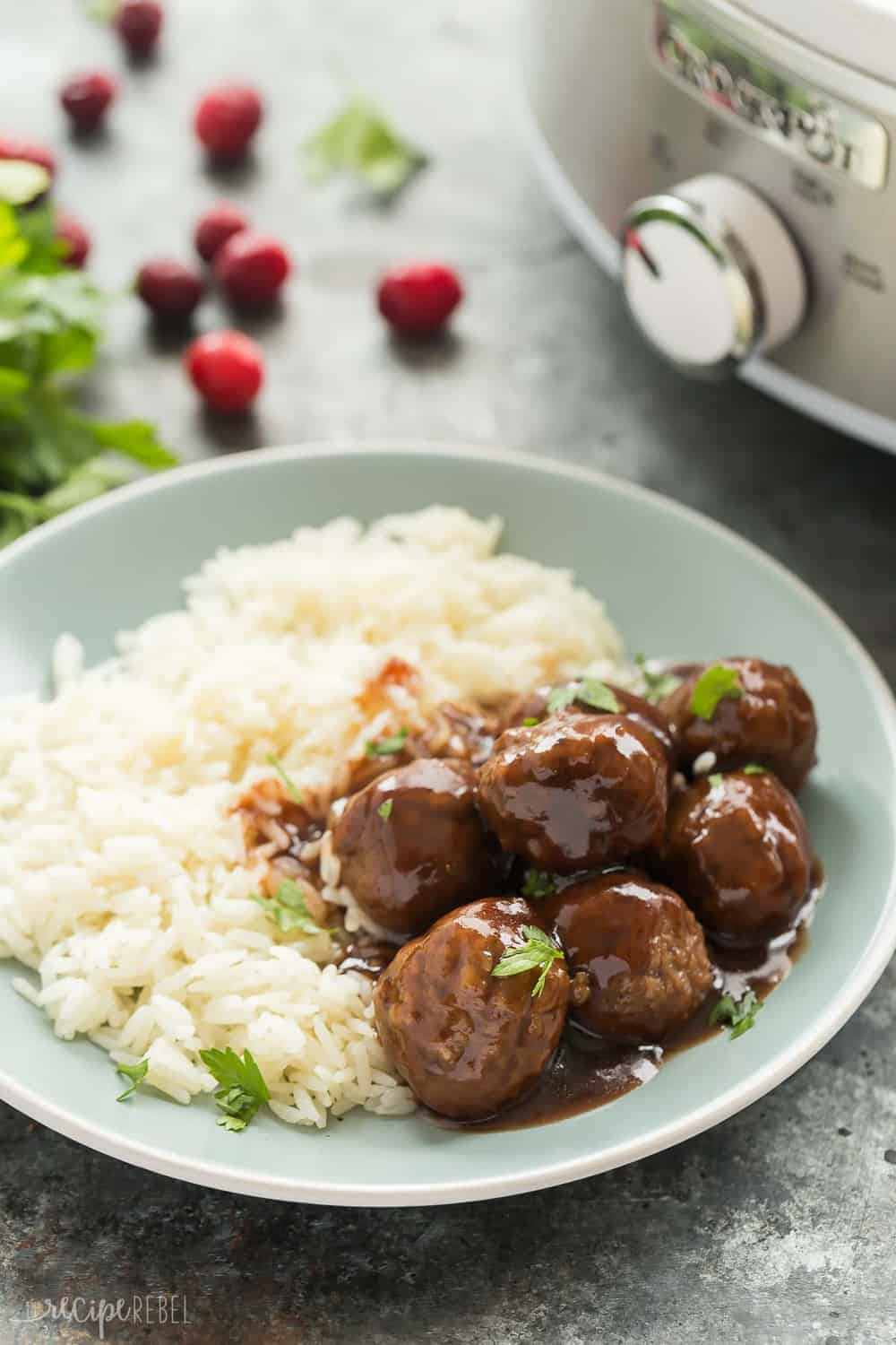 These Slow Cooker Cranberry Balsamic Meatballs are perfect for a holiday dinner or party! Sweet, tangy and so easy! Slow Cooker Cranberry Balsamic Meatballs with white rice on a plate.