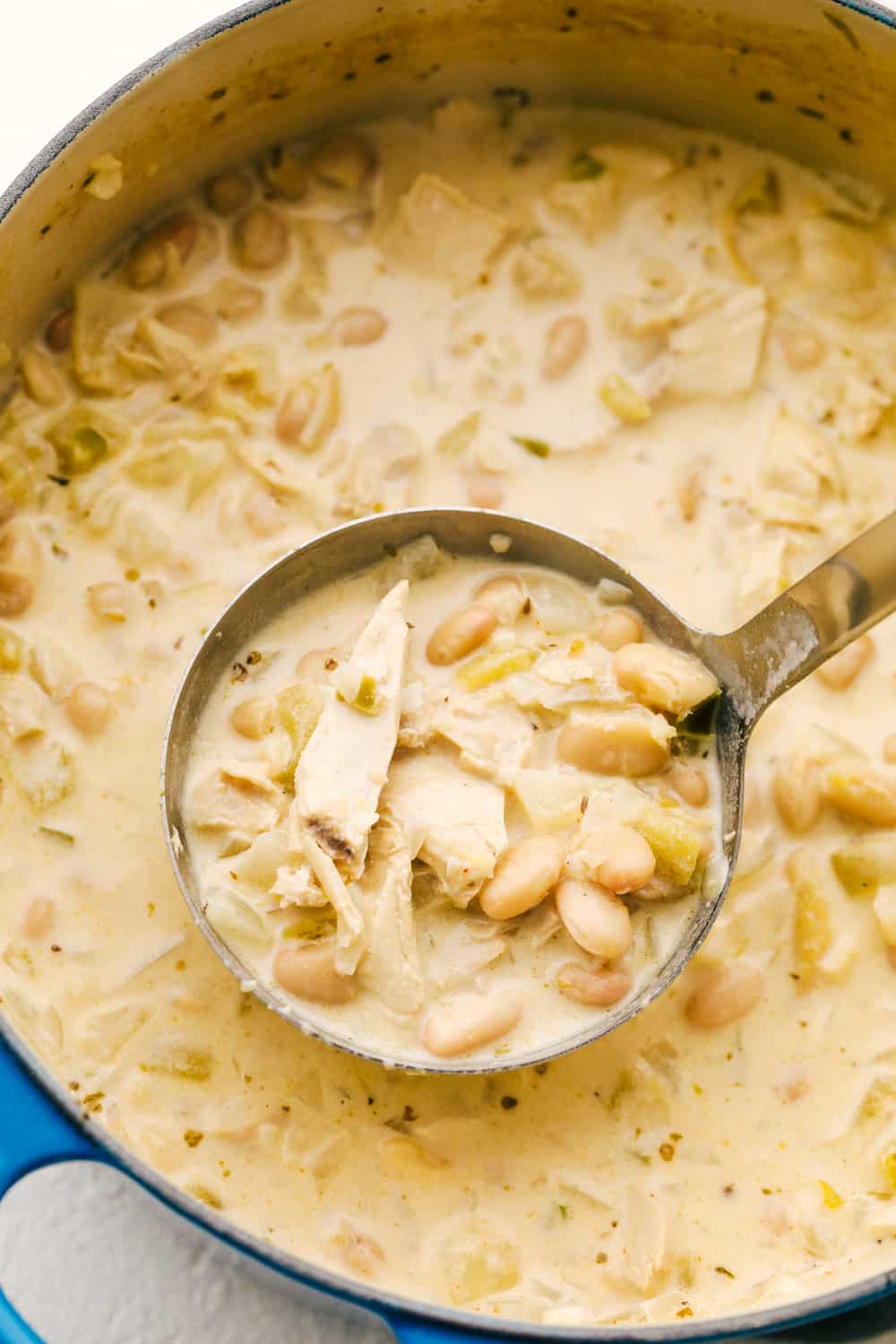 White Chicken Chili is loaded with beans, chicken, green chilies and the most luscious creamy broth. A twist on a classic that's perfect for a cold day. Serve it up with corn bread and a salad and your set for a satisfying comfort meal. Creamy, savory, hearty White Chicken Chili.