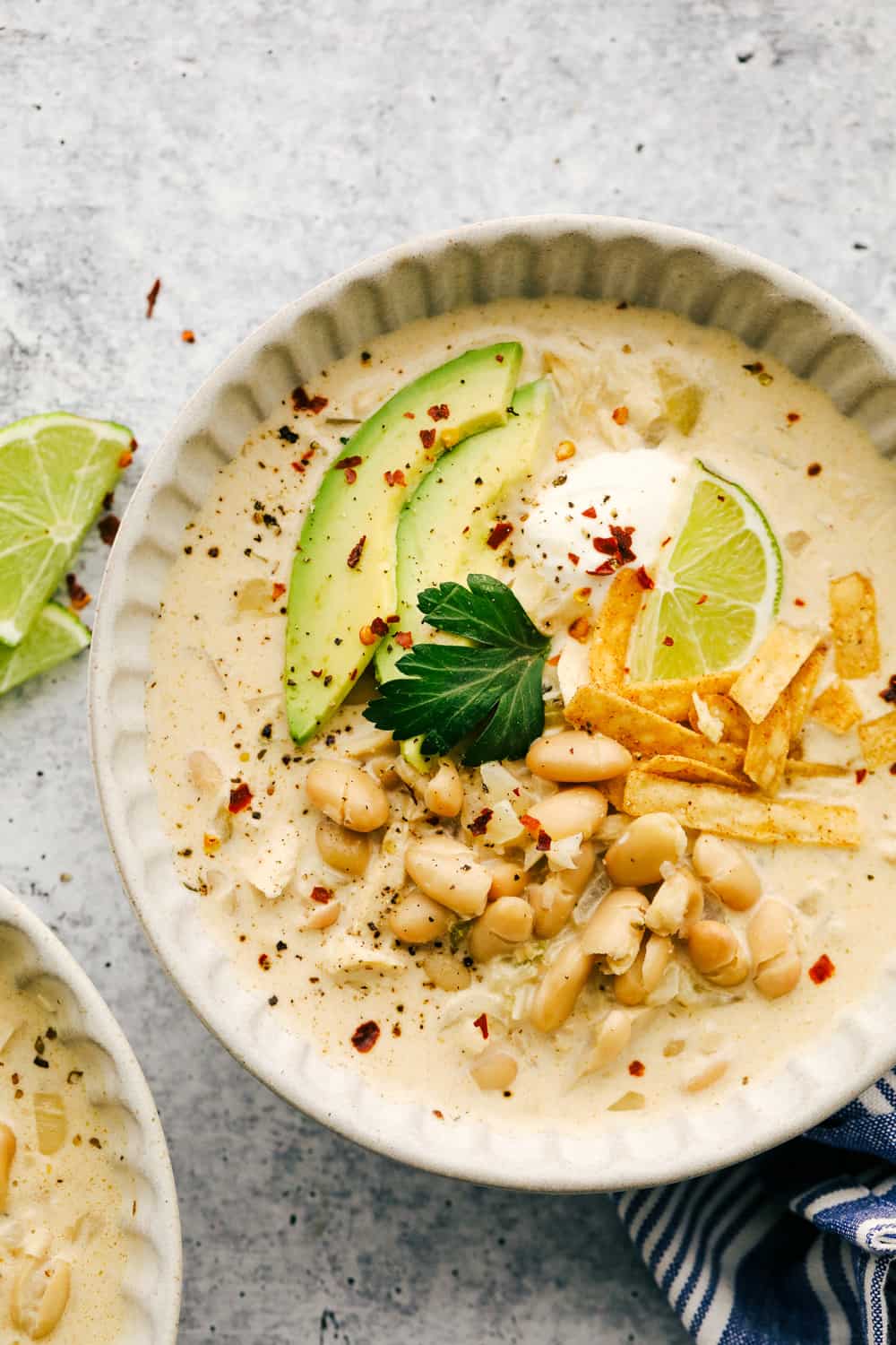 White Chicken Chili is loaded with beans, chicken, green chilies and the most luscious creamy broth. A twist on a classic that's perfect for a cold day. Serve it up with corn bread and a salad and your set for a satisfying comfort meal. Creamy, savory, hearty White Chicken Chili.