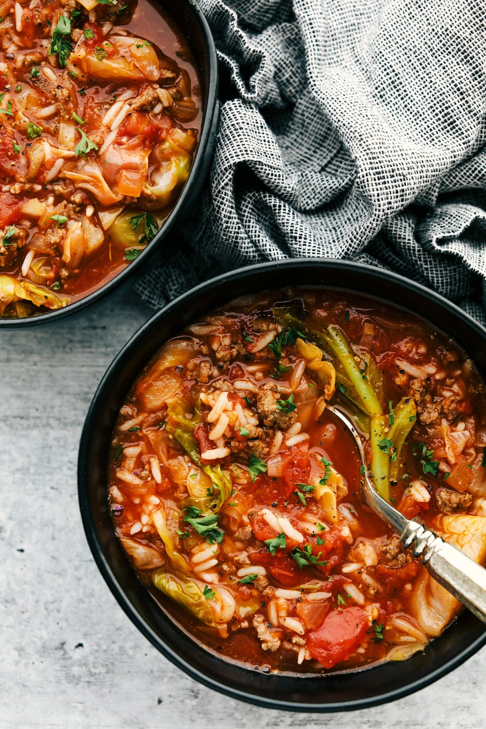 Stuffed Cabbage Soup made with ground beef, rice, cabbage and fresh tomato sauce on your stovetop in just thirty minutes. This hearty rich soup is cozy and perfect for those cold winter nights. It comes together in 30 min so it's easy and ideal for a busy day. Hearty, rich and satisfying Stuffed Cabbage Soup.
