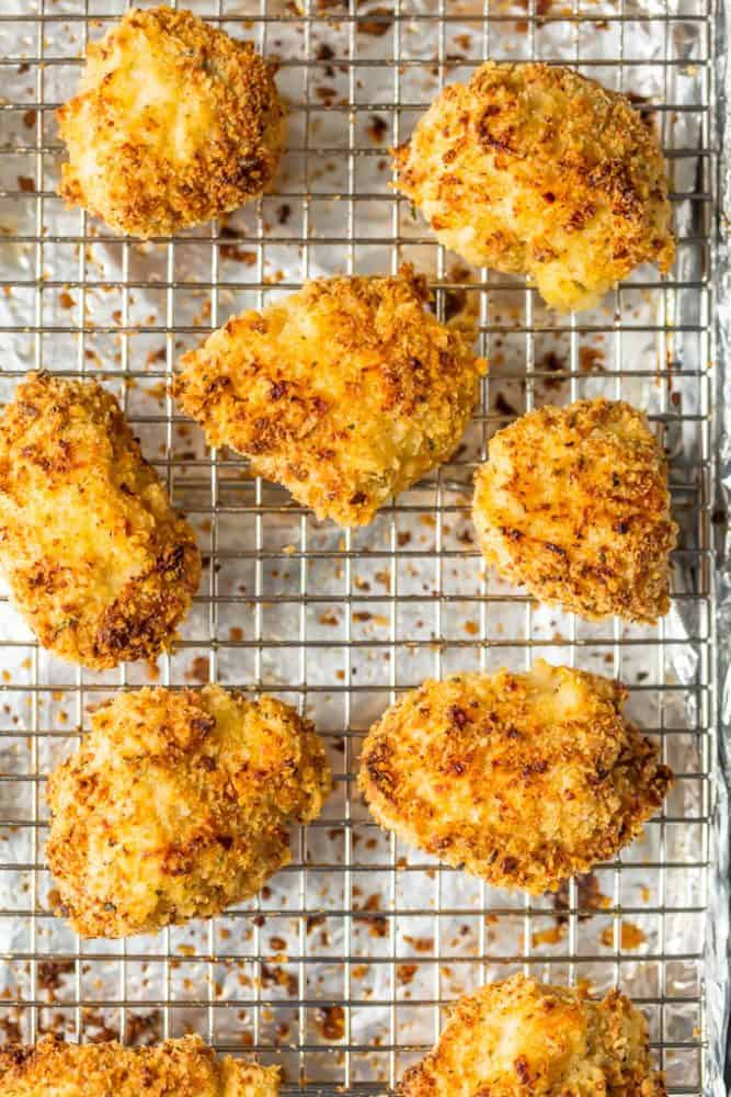 Theseย Baked Parmesan Chicken Nuggets are the perfect easy and healthy meal your entire family will love. Baked Parmesan Chicken Nuggets on a cooking sheet.