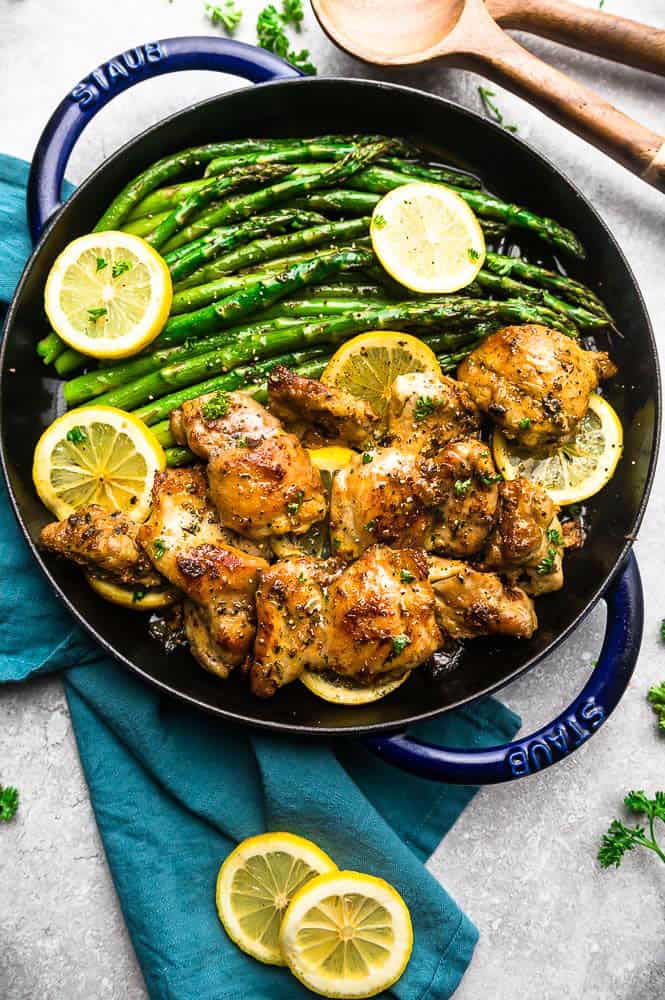 Instant Pot Lemon Garlic Chicken is simple and easy to make in the pressure cooker and perfect for busy weeknights. The chicken cooks up tender and juicy in a buttery lemon garlic sauce. Lemon Garlic Chicken in a Staub pot with asparagus and lemon slices over top.