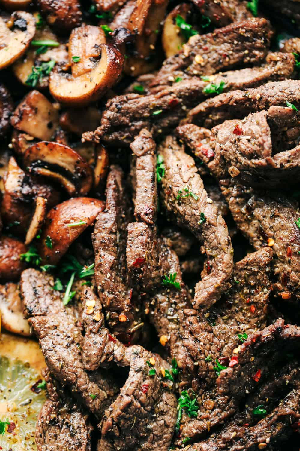 Lemon Garlic Butter Flank Steak with Mushrooms is tender, juicy flank steak cooked in a buttery, lemon garlic sauce mixed with mushrooms for the perfect combination. It is cooked in a skillet to tender perfection and a meal that everyone will love! lemon garlic butter flank steak with mushrooms