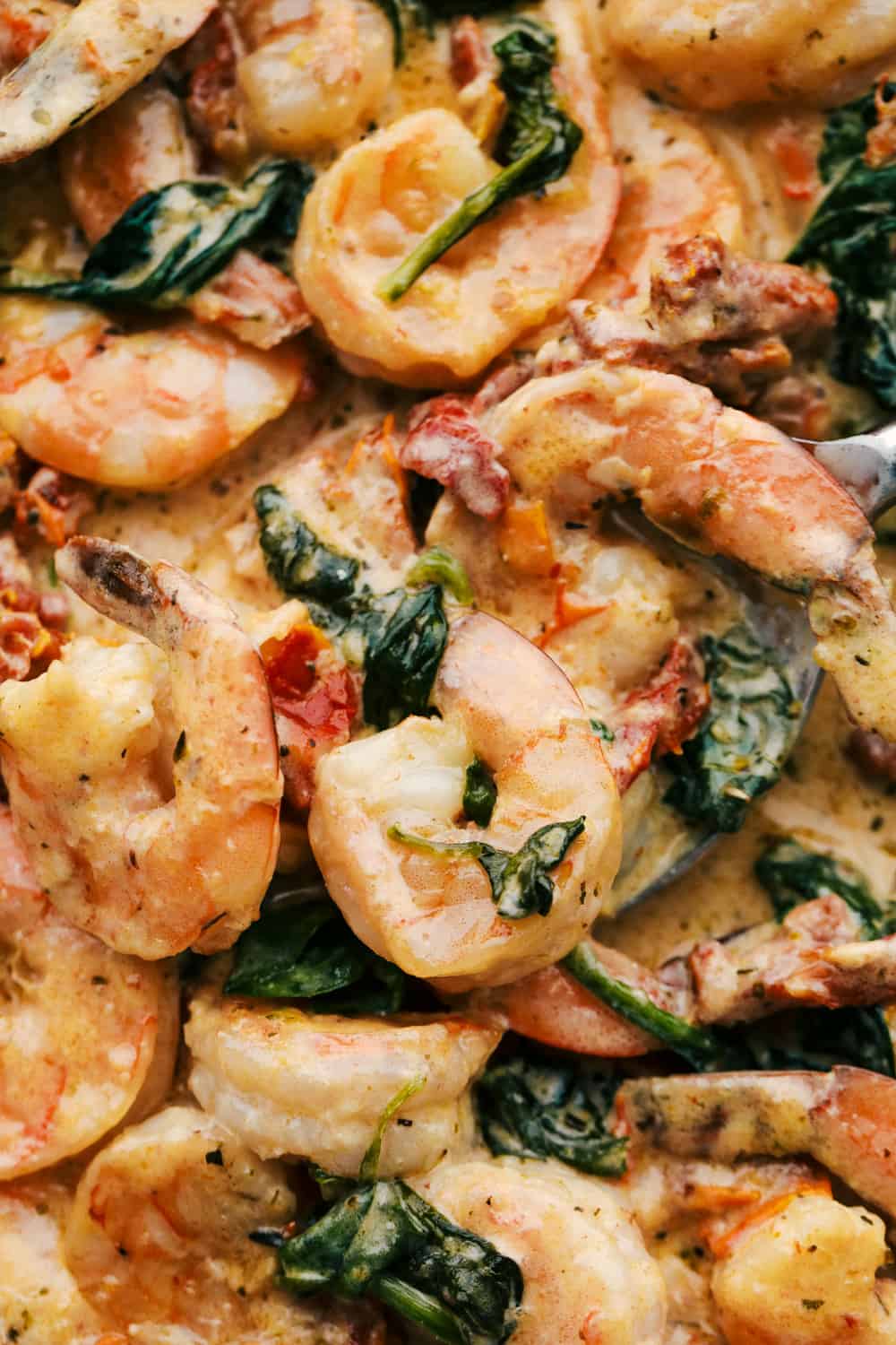 Tuscan Garlic Shrimpย is the most amazing creamy shrimp dish. A creamy garlic parmesan sauce with spinach and sun-driedย tomatoesย creates an unforgettable restaurantย qualityย meal right at home! Upclose picture to see the creamy tuscan garlic shrimp and the incredible texture.