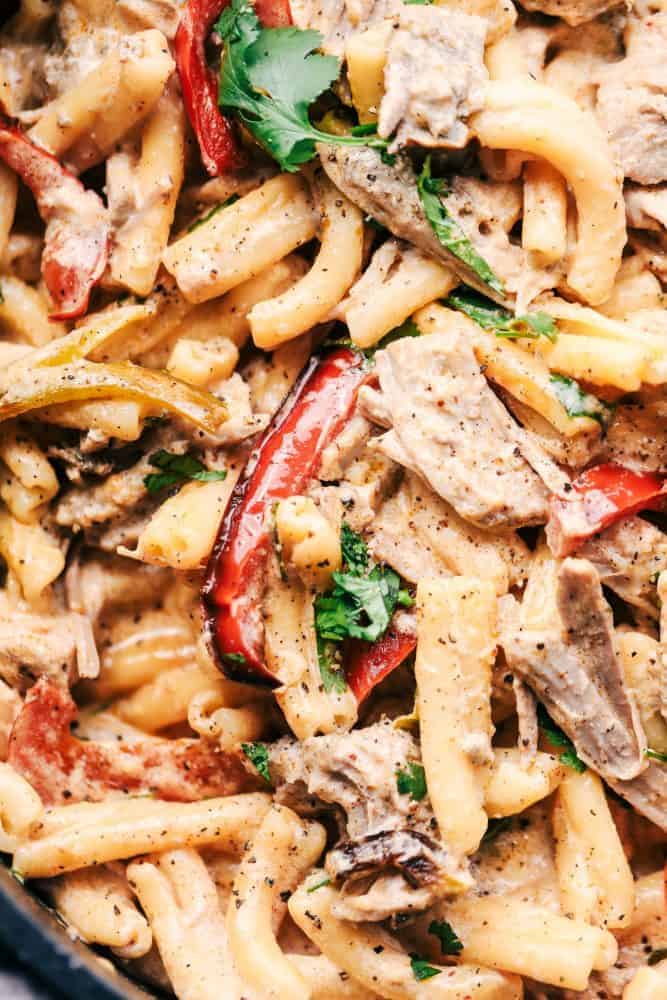 Creamy Pork Carnitas Pasta has crazy tender seasoned fresh pork with peppers and creamy pasta. All of the flavors you love about carnitas packed into a delicious meal! Creamy Pork Carnitas Pasta.