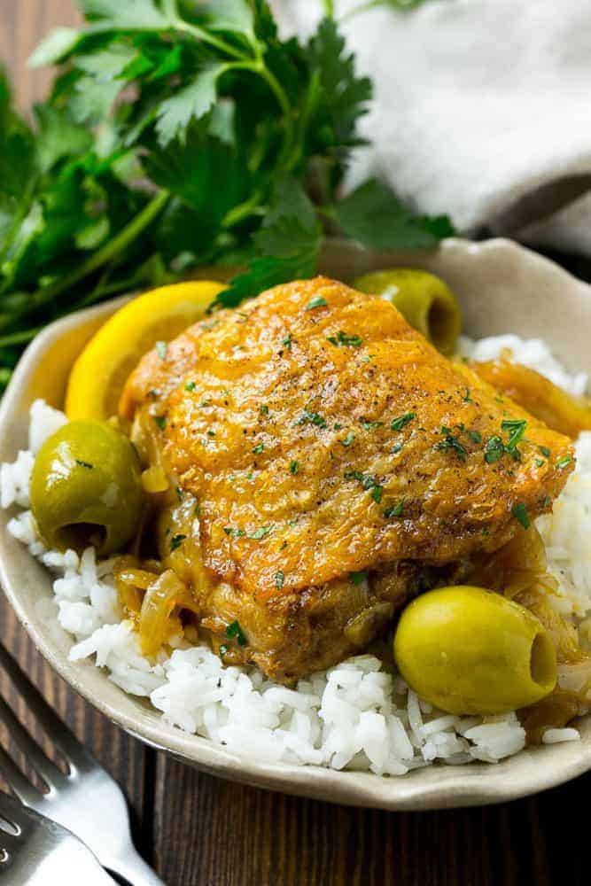 This Moroccan chicken is tender chicken thighs cooked in an aromatic sauce with olives and lemon. An easy dinner that's full of unique flavors! This Moroccan chicken over white rice.