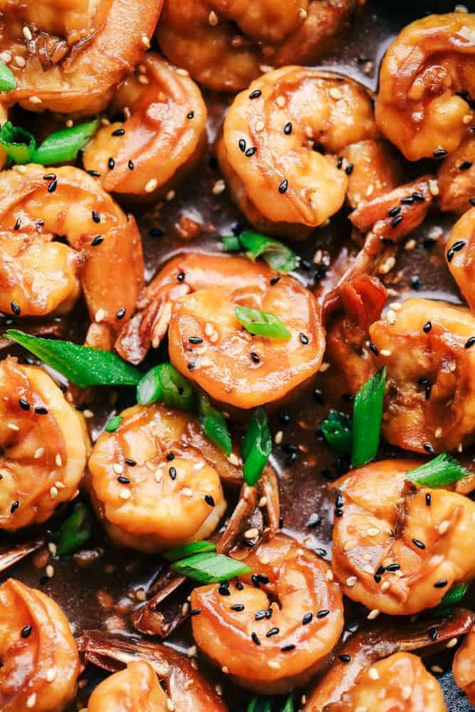 Sticky Sesame Garlic Shrimp is coated in the most amazing sticky Asian sauce and topped with green onions and sesame seeds! This is a quick and easy 30-minute meal that you will make again and again! Close up of Sticky Sesame Garlic Shrimp