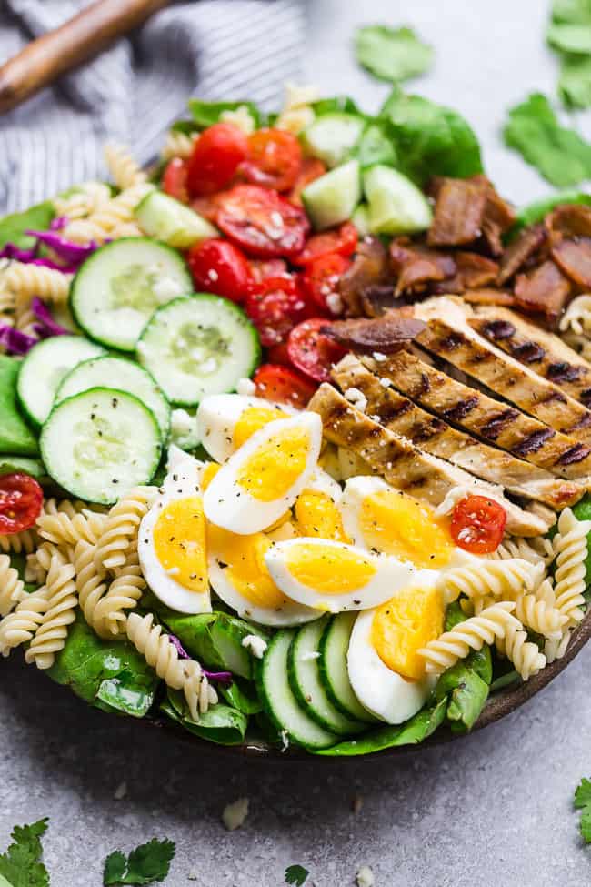 Balsamic Chicken Cobb Salad has all the classic flavors of the popular favorite with a simple balsamic dressing. Made with lettuce, tomatoes, bacon, cucumber, avocado, cheese and rotini - perfect for lunch or your next potluck! Balsamic Chicken Cobb Salad.