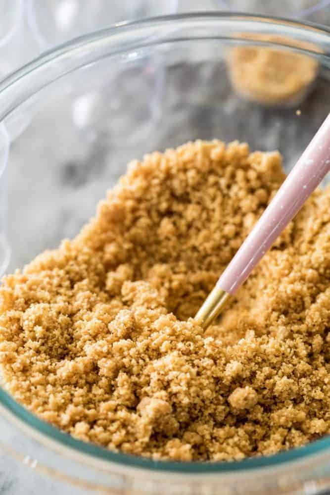 Cheesecake Dessert Cups are served in individually portioned 2-oz shot glasses and are made with a simple graham cracker crust and a creamy no-bake cheesecake filling! Finish yours off with your favorite toppings, like whipped cream or fruit pie filling! Graham cracker crust for cheesecake dessert cups.