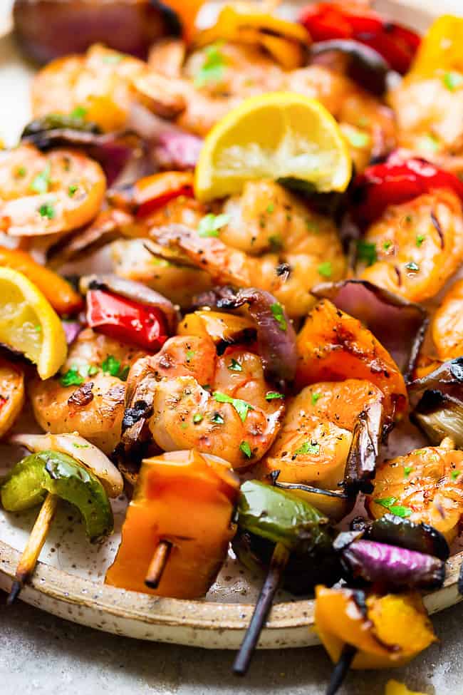 Grilled Lemon Garlic Butter Shrimp with Vegetables - a simple and tasty recipe for summer grilling. Juicy shrimp and tender veggies are coated in an amazing buttery lemon garlic blend that are grilled to perfection. Close up of Grilled Lemon Garlic Butter Shrimp with Vegetables.