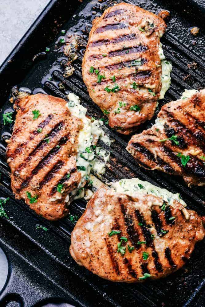 Grilled Spinach and Herb Stuffed Pork Chops are so easy to make and stuffed with a creamy parmesan spinach and herb mixture that takes these delicious and full of flavor pork chops to the next level! Cooked Herb Stuffed Pork Chops on a grill pan.
