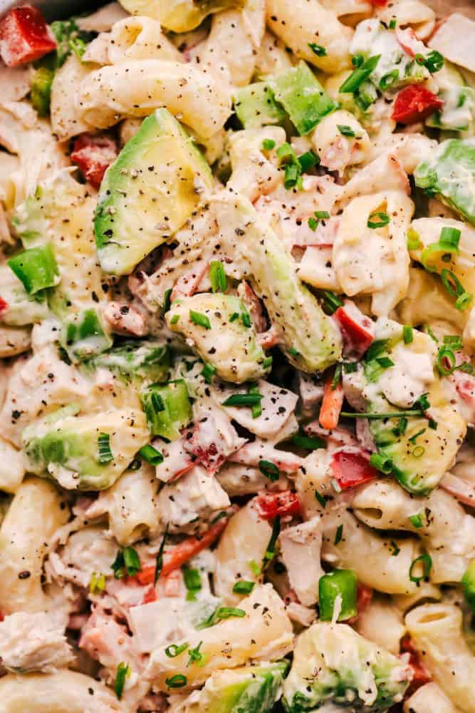 Tuna Avocado Macaroni Salad is an AMAZING creamy macaroni salad that is filled with chopped veggies, avocado, and tuna. This is going to impress everyone at your next potluck! Close up of Tuna Avocado Macaroni Salad.