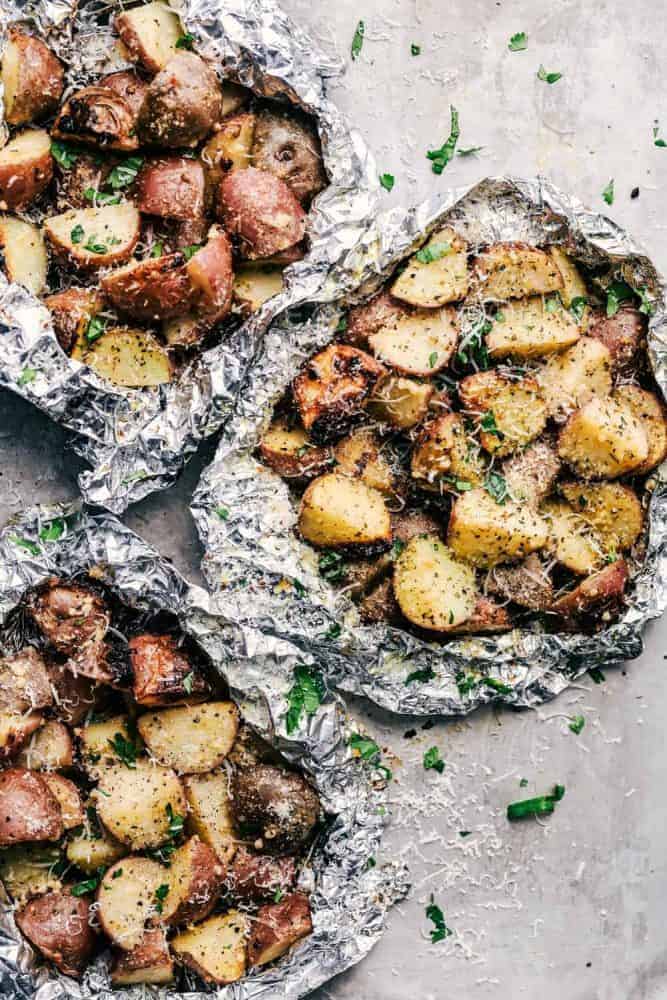 Parmesan Garlic Potato Foil Packets are potatoes that get cooked to tender perfection and have the best parmesan garlic flavor! ย These make an amazing side dish to any meal!ย Three Parmesan Garlic Potato Foil Packets.