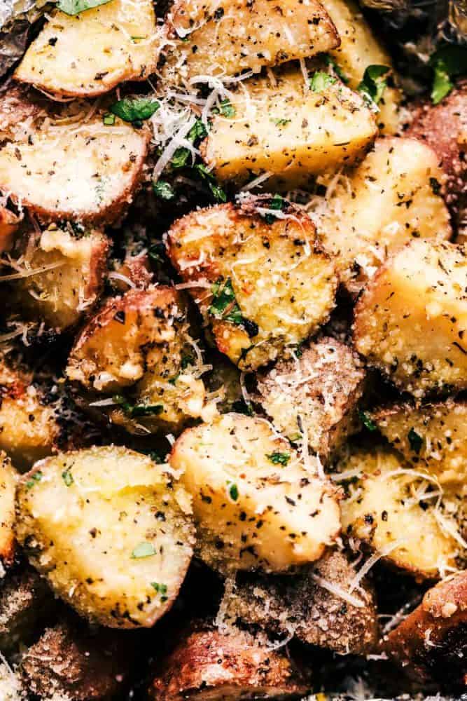 Parmesan Garlic Potato Foil Packets are potatoes that get cooked to tender perfection and have the best parmesan garlic flavor! ย These make an amazing side dish to any meal!ย Close up of Parmesan Garlic Potatoes.