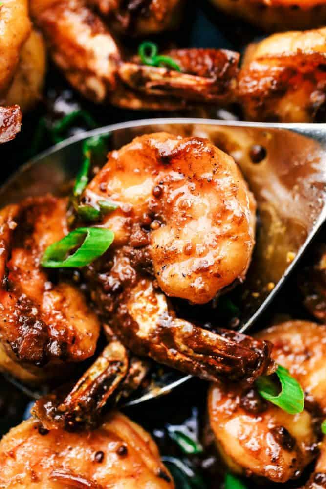 Cajun Garlic Butter Shrimp is made in the most amazing cajun garlic butter sauce. This is ready in 15 minutes and a meal that will wow the family! Close-up of a spoonful of Cajun Garlic Butter Shrimp.