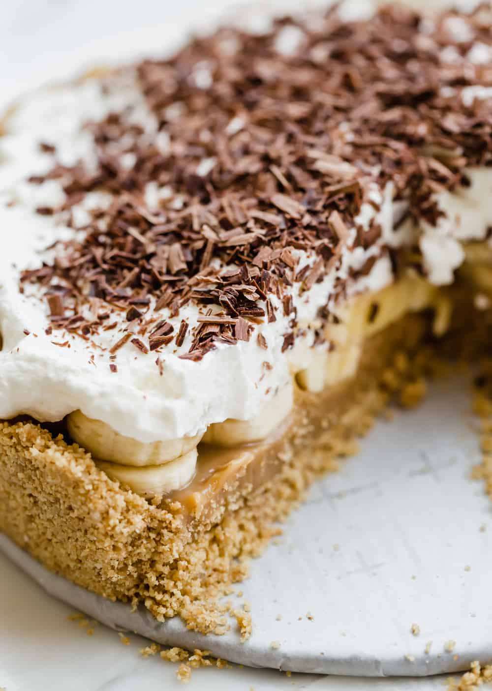 Banoffee Pie is a popular dessert in Britain with a caramel toffee filling topped with bananas, whipped cream, and chocolate shavings. ย This is such an insanely delicious pie that you won't be able to get enough of!ย Banoffee Pie