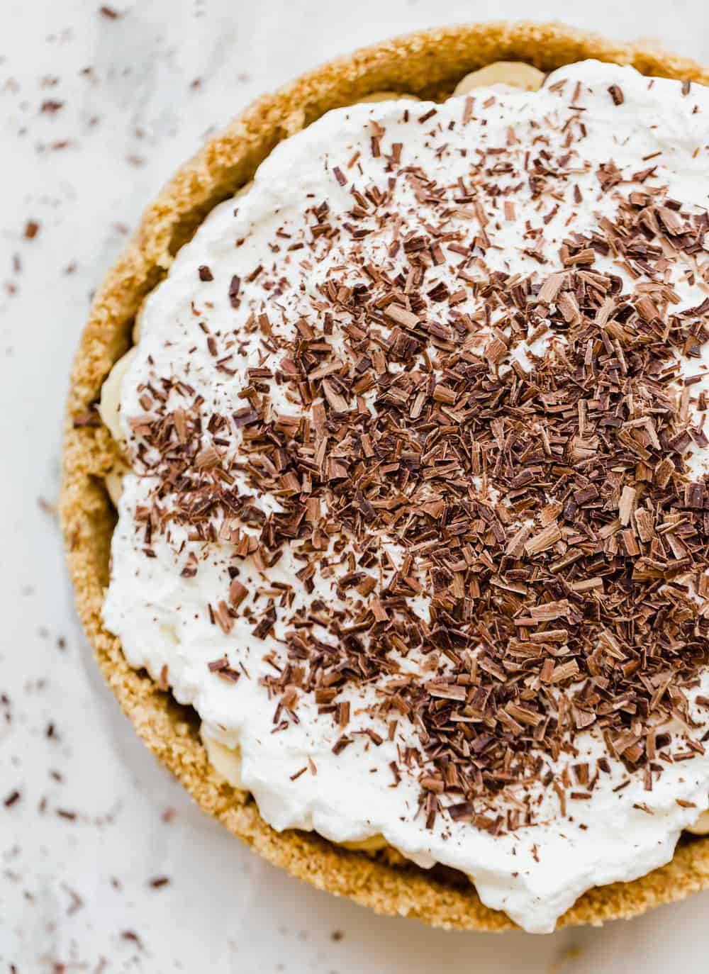 Banoffee Pie is a popular dessert in Britain with a caramel toffee filling topped with bananas, whipped cream, and chocolate shavings. ย This is such an insanely delicious pie that you won't be able to get enough of!ย Banoffee Pie