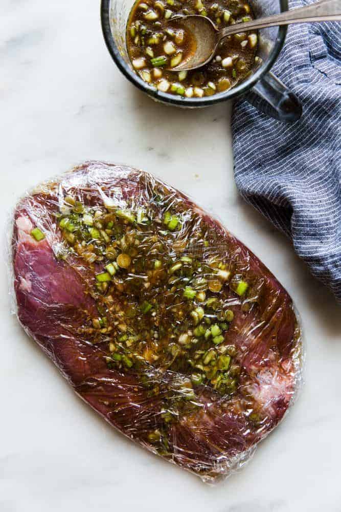 Brown Sugar Garlic Flank Steak is made with the most amazing brown sugar garlic soy marinade. The steak is grilled to perfection and melt in your mouth delicious!ย Brown Sugar Garlic Flank Steak wrapped in Reynolds Plastic Wrap.
