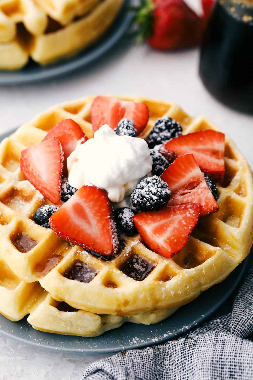 There’s nothing like my homemade Belgian waffles! They're crisp on the outside, soft and fluffy inside, with deep pockets for all the syrup and butter. The secret is whipping the egg whites for that light, airy texture! Belgian waffles with strawberries, blackberries, and whipped cream.
