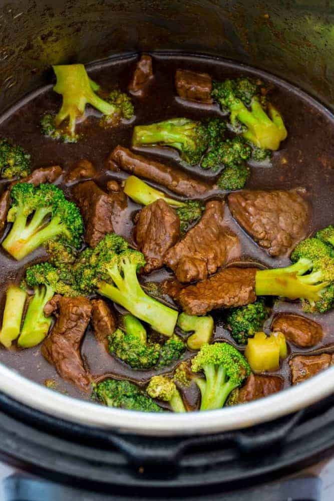 Instant Pot Beef and Broccoli is a flavorful Chinese meal made in minutes by pressure cooking. For this recipe slices of beef chuck are marinated in a sesame, soy, ginger, and garlic mixture. The beef is cooked until tender in a soy and oyster sauce base. Broccoli florets are steamed in the Instant Pot until crisp-tender. The dish can be served with rice and garnished with sesame seeds. Making beef and broccoli in an Instant Pot.