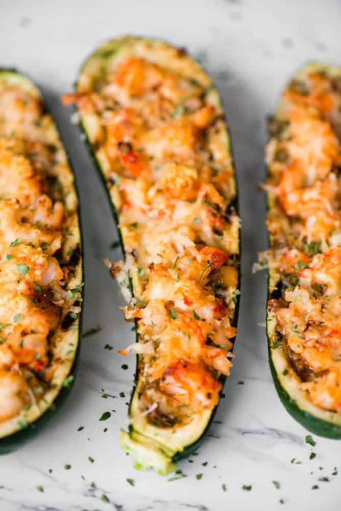 Shrimp Zucchini Boats with succulent pieces of shrimp and artichokes topped with parmesan cheese are a great low carb and tasty way to enjoy zucchini! Shrimp Zucchini Boats.