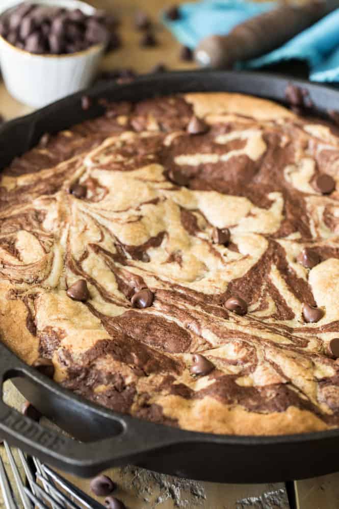 This decadent deep dish skillet brownie cookie is always a crowd pleaser! Freshly baked skillet brownie cookie in a skillet.