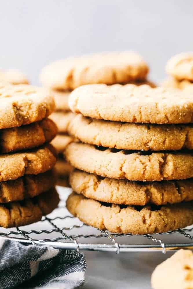 Perfectly Soft Peanut Butter Cookies are such a classic recipe! This recipe makes the most perfect and soft peanut butter cookies. This will be the only recipe you ever need! Stacks of soft peanut butter cookies on a cooling cookie rack.