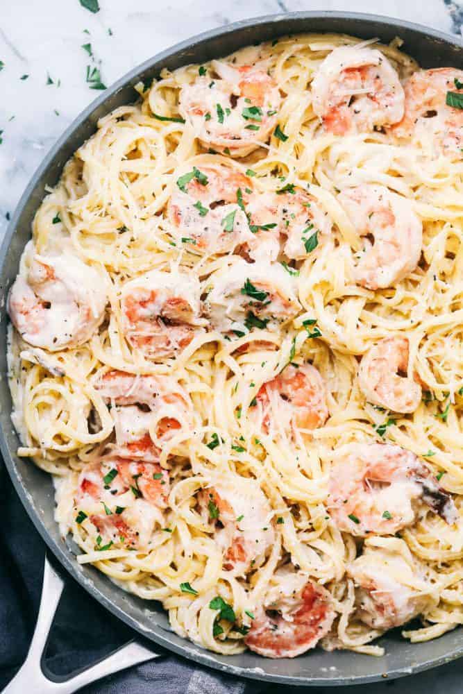 Creamy Garlic Shrimp Alfredo Pastaย is such a classic meal that is brought to its BEST with Shrimp. This meal takes little effort and is so creamy and delicious the entire family will go crazy for!ย Creamy garlic shrimp Alfredo pasta and a skillet.