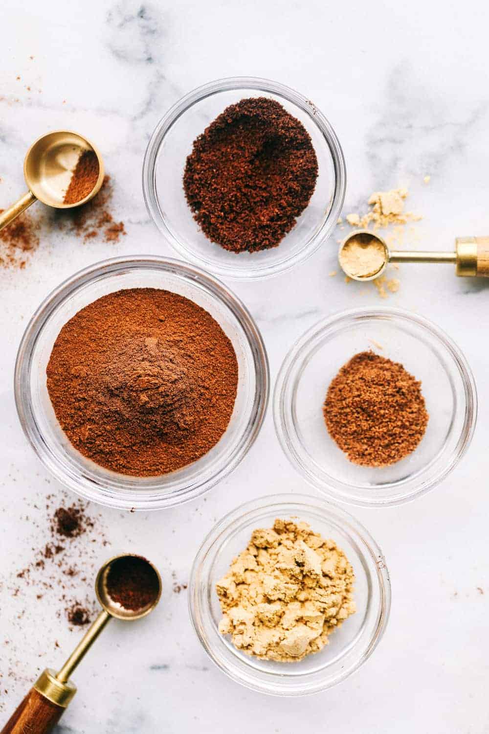 This guide gives you easy swaps that actually work. Save this list and come back to it anytime you need a quick answer! A top view of seasonings in bowls.