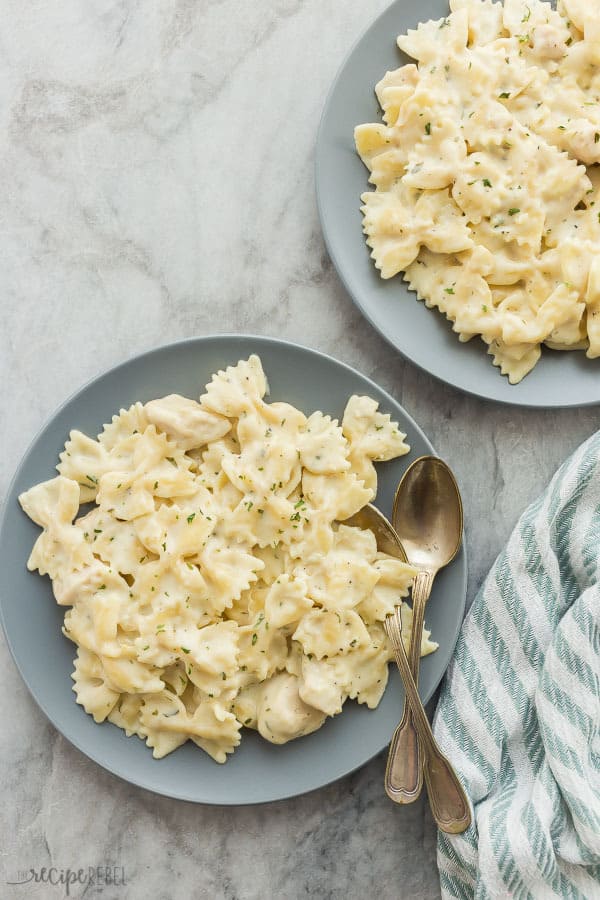 This Instant Pot Chicken Alfredo Pasta is an easy, one pot meal that cooks in record time! It's creamy, comforting and hearty! Instant pot chicken alfredo overhead on two grey plates.