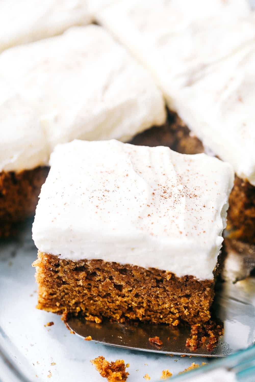 This Pumpkin Cake is the most amazing pumpkin cake you will ever make! ย Perfectly spiced and moist and topped with the most epic cream cheese whipping cream frosting! Pumpkin cake with frosting