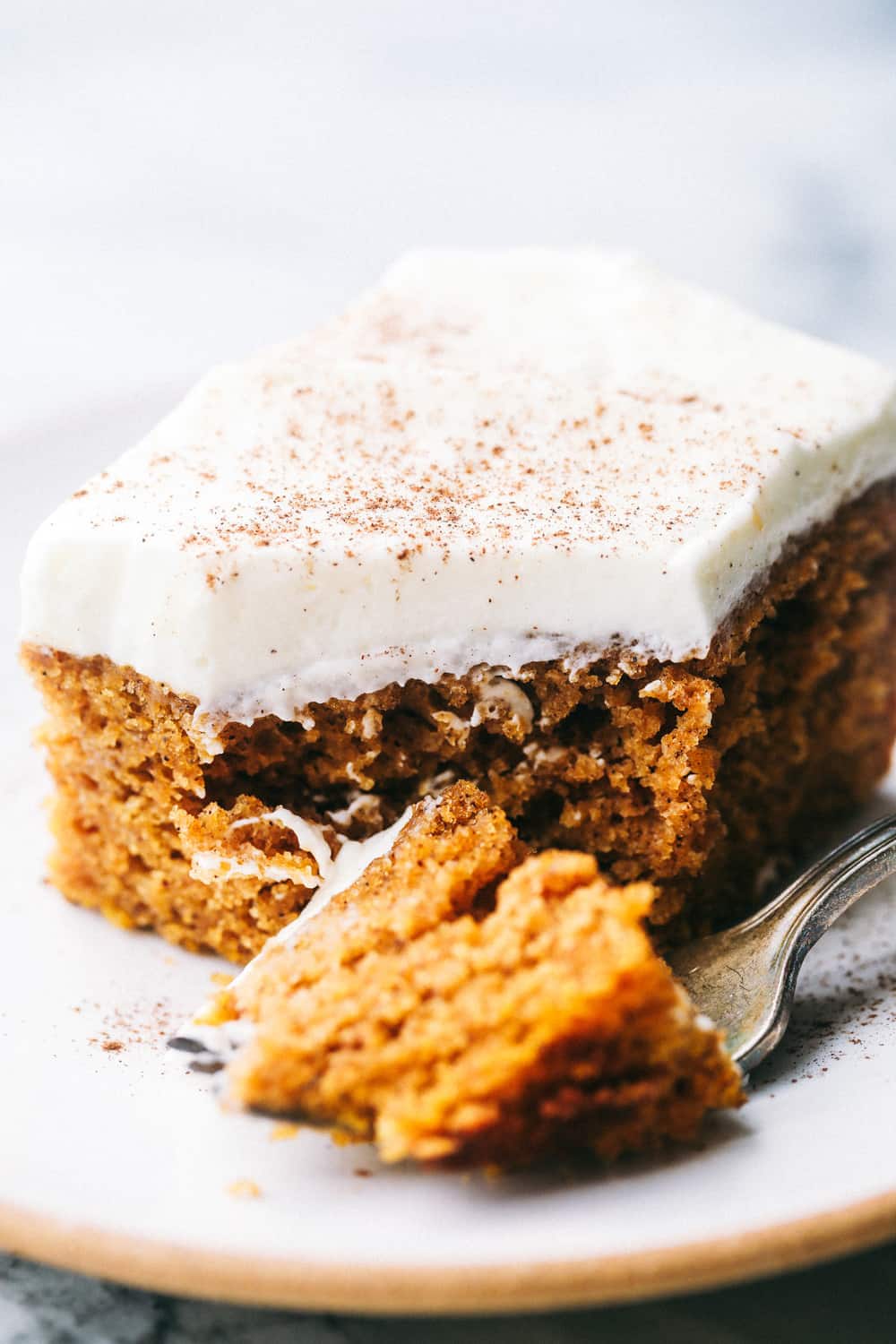 This Pumpkin Cake is the most amazing pumpkin cake you will ever make! ย Perfectly spiced and moist and topped with the most epic cream cheese whipping cream frosting! pumpkin cake