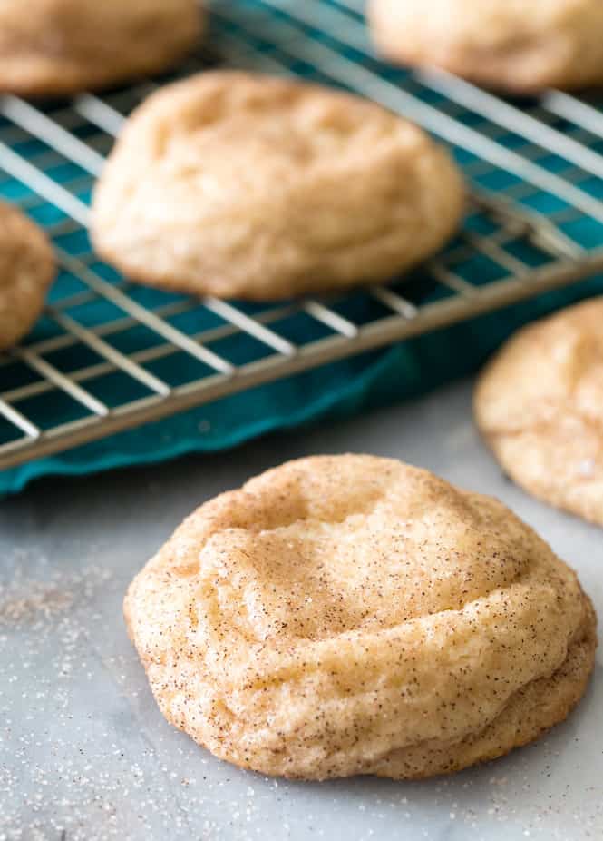 These Cream Cheese Snickerdoodles are extraordinarily soft and absolutely melt in your mouth! The cream cheese adds a subtle extra tang to a classic Snickerdoodle cookie. Youโre going to want to try this one out for your holiday cookie tray (or, really, for anytime!). Cream Cheese Snickerdoodle cooling after baking.