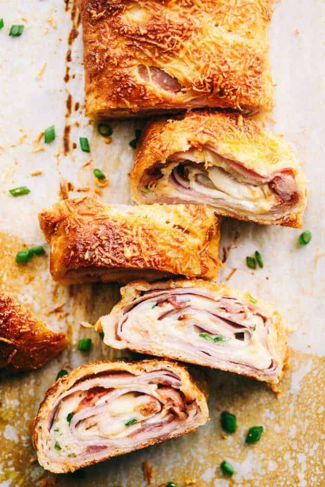 Easy Ham and Swiss Stromboliย can be anything you want it to be! Breakfast? Yes. Brunch? You bet. Dinner? Of course! This meal is a triple threat. It's easy enough to be a side dish. But so good it will be the star of the table.ย Ham and Swiss Stromboli sliced and ready for serving.