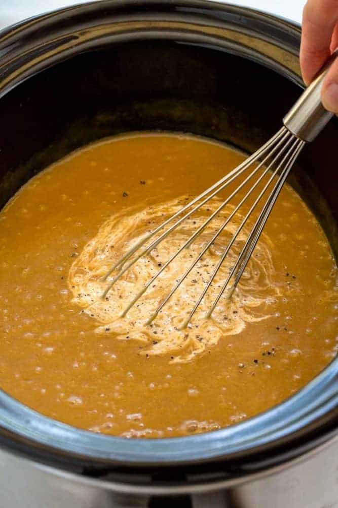 Slow Cooker Potato Leek Soup serves up a satisfying bowl of creamy pureed vegetables. The caramelized onions and leeks bump up the flavor as it gently simmers with the flaky potatoes and herbs. You wonโt believe how easy it is to create a restaurant quality dish in the crock-pot! Whisk mixing cream into potato leek soup.