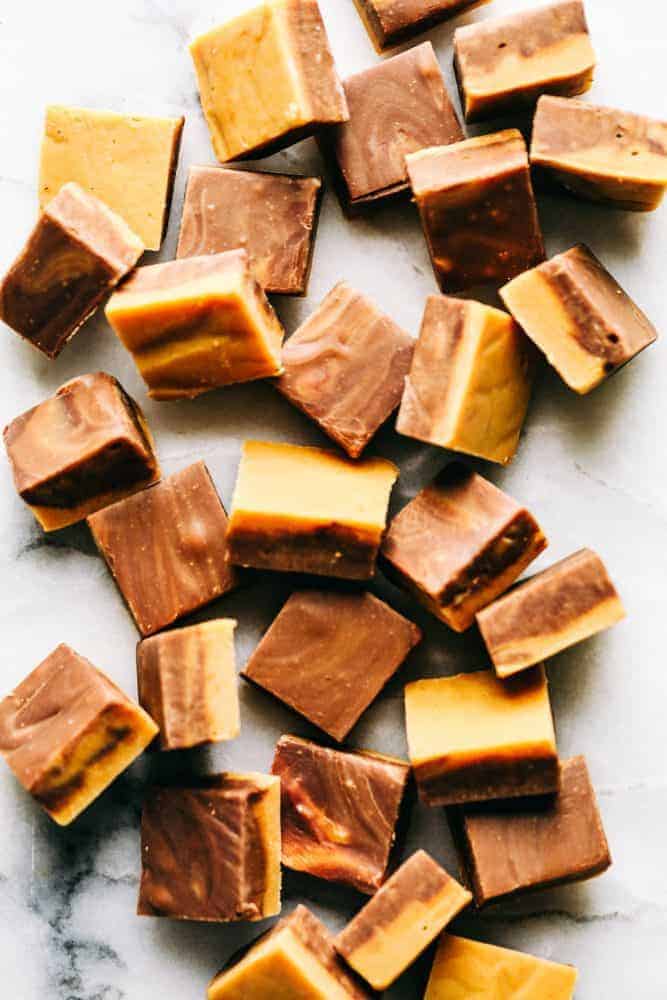 Peanut Butter Chocolate Fudge is an awesome take on the best dynamic duo out there! You cant go wrong with Peanut Butter and Chocolate! Peanut butter chocolate fudge scattered about on a granite countertop.