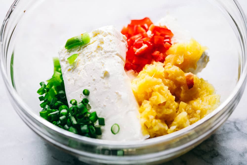 Pineapple Cheese Ball is the next best twist on a favorite classic. With Different textures and flavors it will be the hit at your next gathering! Then gradients to make pineapple cheese ball and a glass bowl.