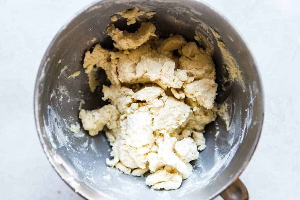 Chocolate Peppermint Dipped Shortbread Cookies are buttery, melt in your mouth shortbread cookies that get dipped in chocolate and sprinkled with crushed peppermint. These cookies make the perfect holiday treat! Dough in a mixer for shortbread cookies.
