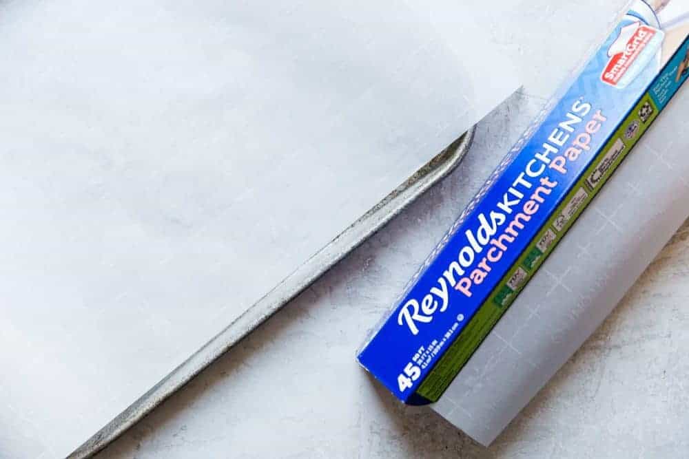 Chocolate Peppermint Dipped Shortbread Cookies are buttery, melt in your mouth shortbread cookies that get dipped in chocolate and sprinkled with crushed peppermint. These cookies make the perfect holiday treat! Box of Reynolds Kitchens Parchment Paper.