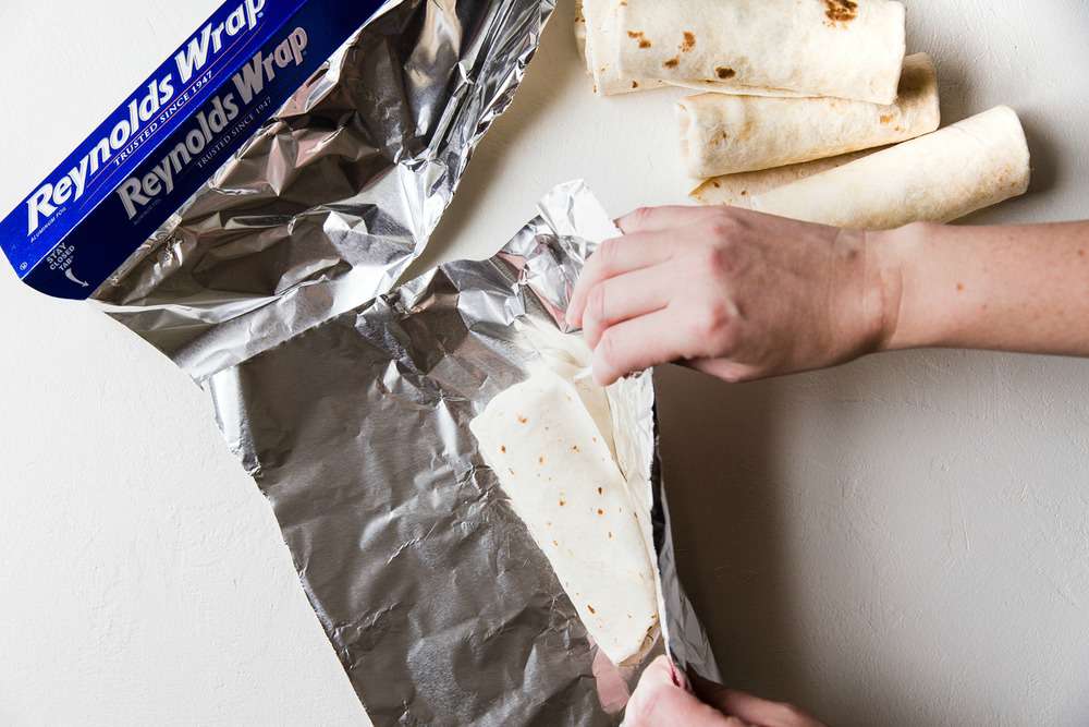 Easyย Mini Burritosย are packed with groundย chicken, pinto beans, Pico deย Gallo and flavorfulย Mexican rice. A classic burrito that is ready to show your tastebuds the next level. These Mini Burritos will leave you wanting more! Wrap the burrito in aluminum foil.