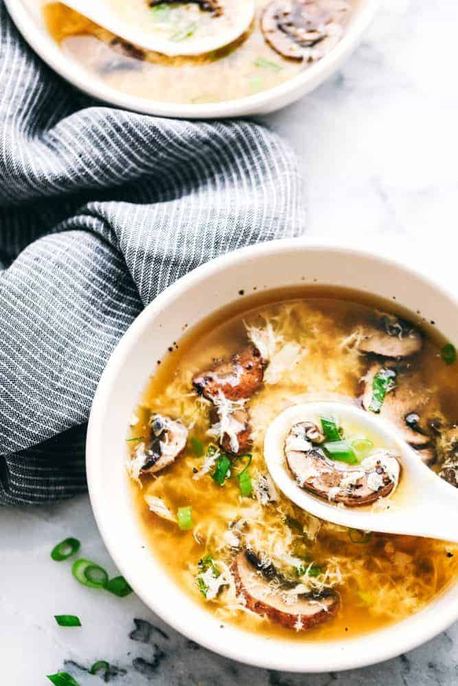 Egg Drop Soupย is a warm,ย thickened broth, with rich flavors of chicken andย beautiful eggย ribbons throughout.ย Enjoy this savory, simple to make soup recipe that comes together in just 15 minutes. Egg drop soup in a bowl with a spoon scooping some up.