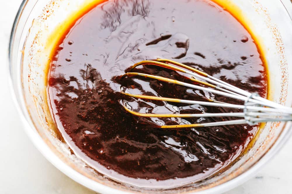 Slow Cooker BBQ Chicken slow cooks to perfection in the best sweet and tangy homemade BBQ sauce. The chicken is so tender and just melts in your mouth with the most amazing flavor! Whisking slow Cooker BBQ sauce.