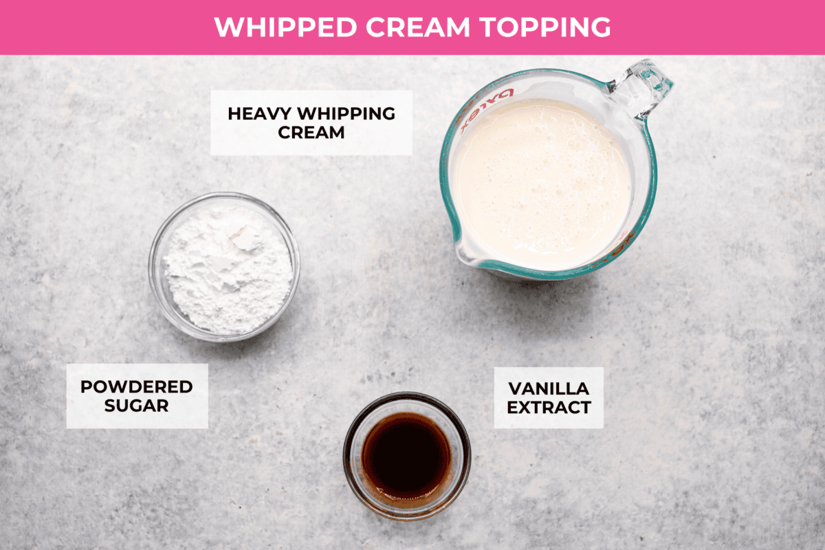 This tender Tres Leches cake is drenched in a three-milk mixture and is topped with fluffy whipped cream, cinnamon, or fresh fruit for a truly authentic Mexican dessert. Overhead shot of labeled whipped cream topping ingredients.
