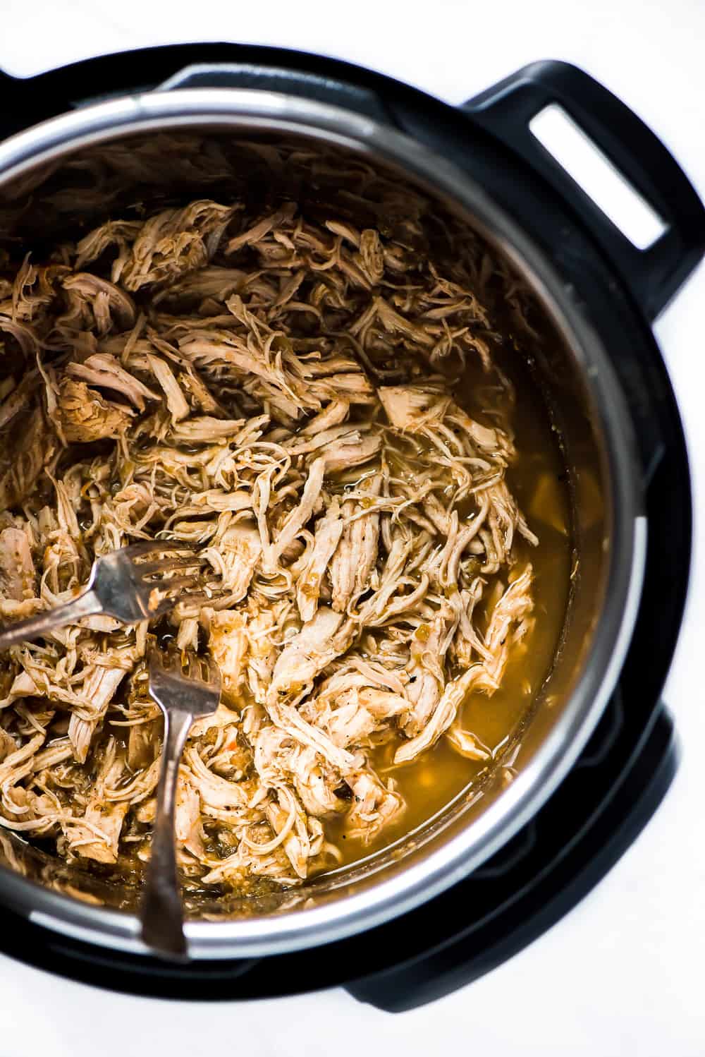 Instant Pot Salsa Verde Chicken Tacos are a family favorite weeknight meal! The flavorful chicken is so quick and easy to make and can be topped with an endless possibility of toppings.ย Cooked chicken in the crock pot.