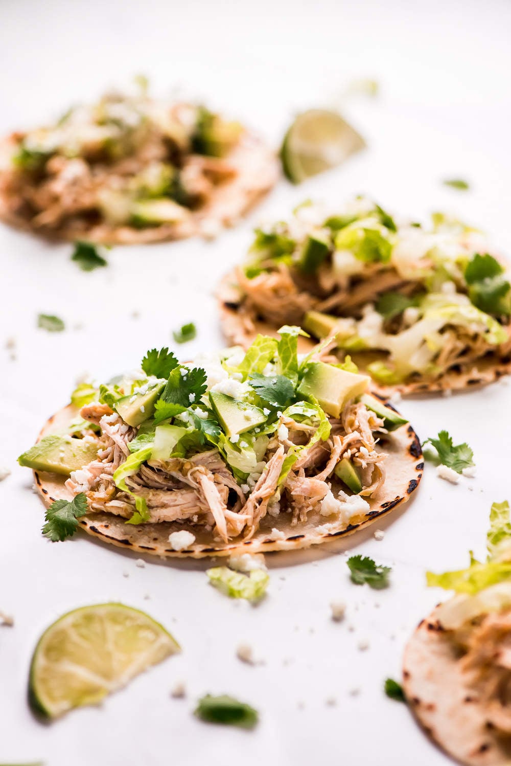Instant Pot Salsa Verde Chicken Tacos are a family favorite weeknight meal! The flavorful chicken is so quick and easy to make and can be topped with an endless possibility of toppings.ย Salsa Verde Chicken Tacos opened out to show the inside ingredients.