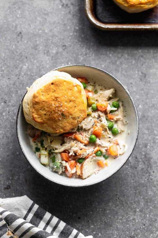 Slow Cooker Chicken Pot Pie is creamy, hearty and addictively delicious. It's packed with tender chicken, crisp veggies, a sauce that will leave you coming back or more, and buttery store-bought biscuits. Perfect for cold and busy winter weeknights! slow cooker chicken pot pie