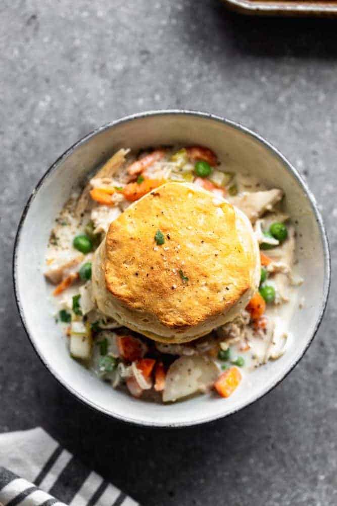 Slow Cooker Chicken Pot Pie is creamy, hearty and addictively delicious. It's packed with tender chicken, crisp veggies, a sauce that will leave you coming back or more, and buttery store-bought biscuits. Perfect for cold and busy winter weeknights! slow cooker chicken pot pie