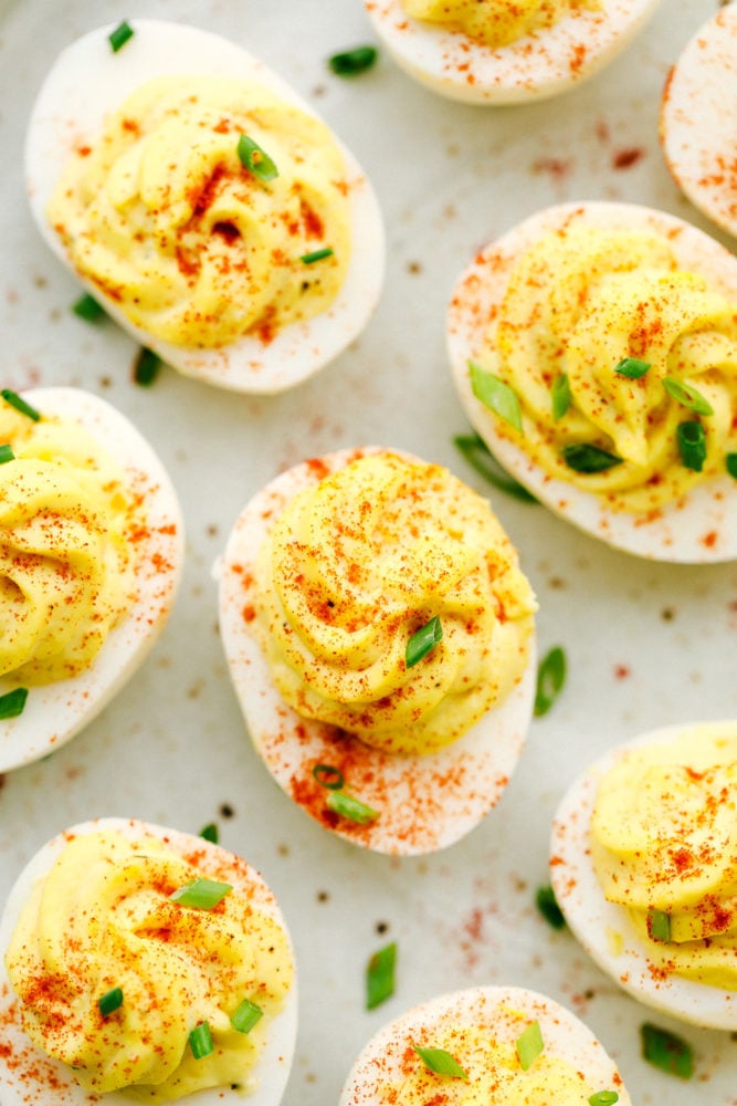 Classic Deviled Eggs are a favorite appetizer for parties and holiday celebrations. This traditional deviled egg recipe is simple and perfect! Deviled eggs with paprika over top.